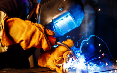 Worker cutting metal with plasma equipment. on plant